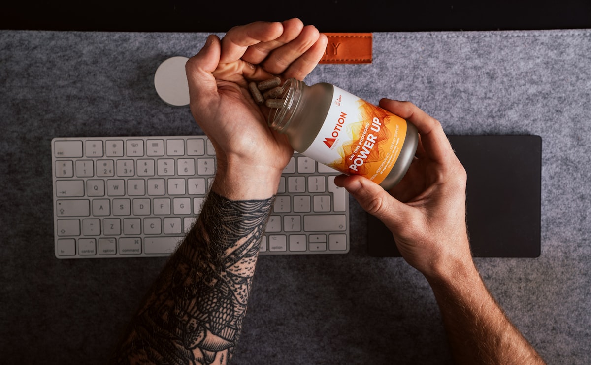 Man reviewing vitamin supplements and nutrition guide